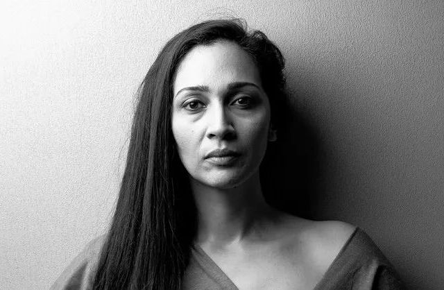 Studio black and white portrait of a woman with textured background in Mauritius